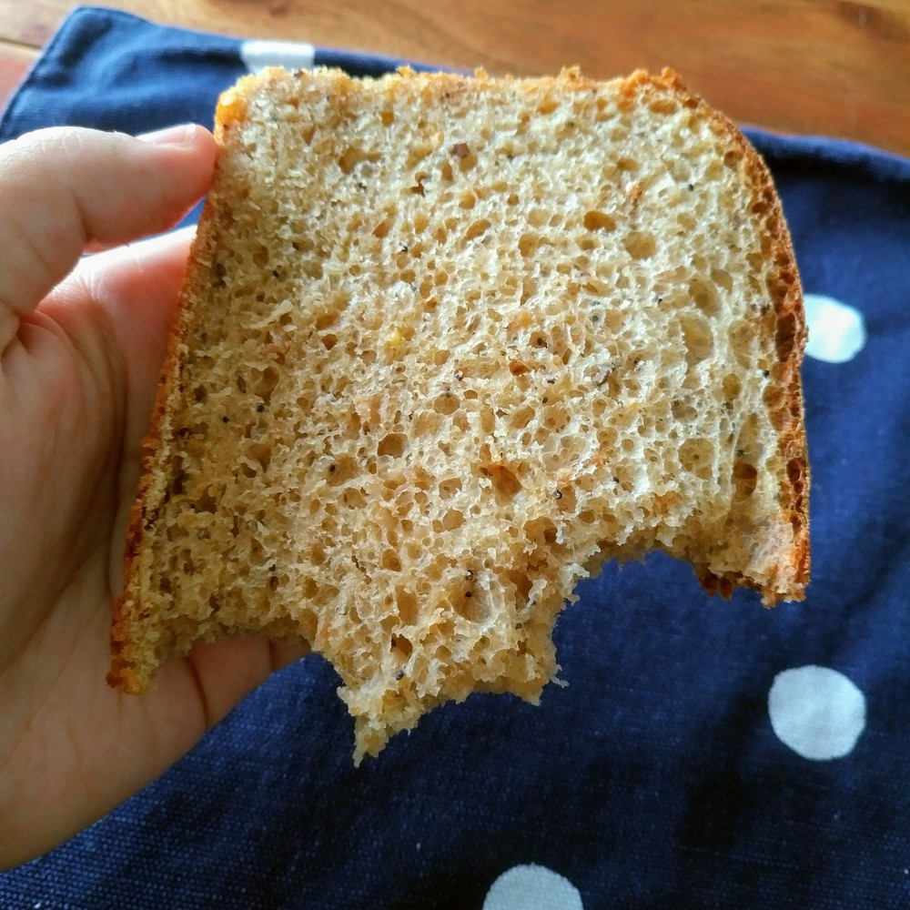 An irresistable slice of bread, revealing little bubbles and seeds